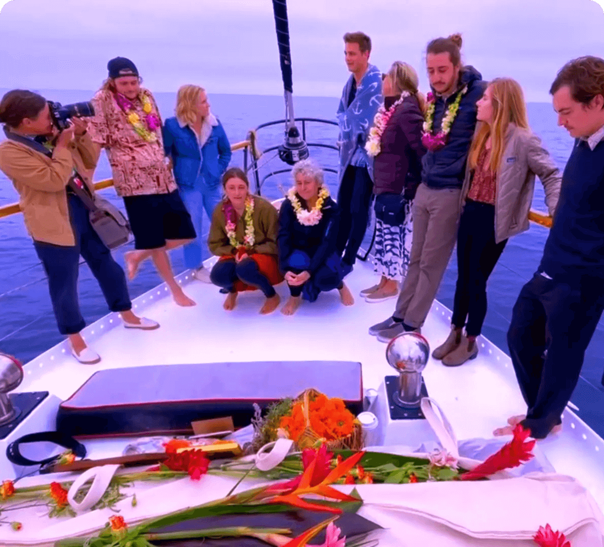 People gathered on a boat with flowers.