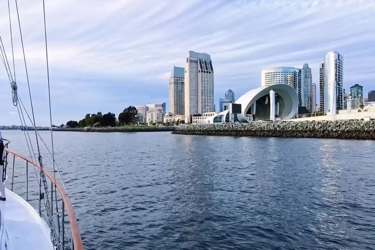Bow of boat facing modern waterfront pavilion