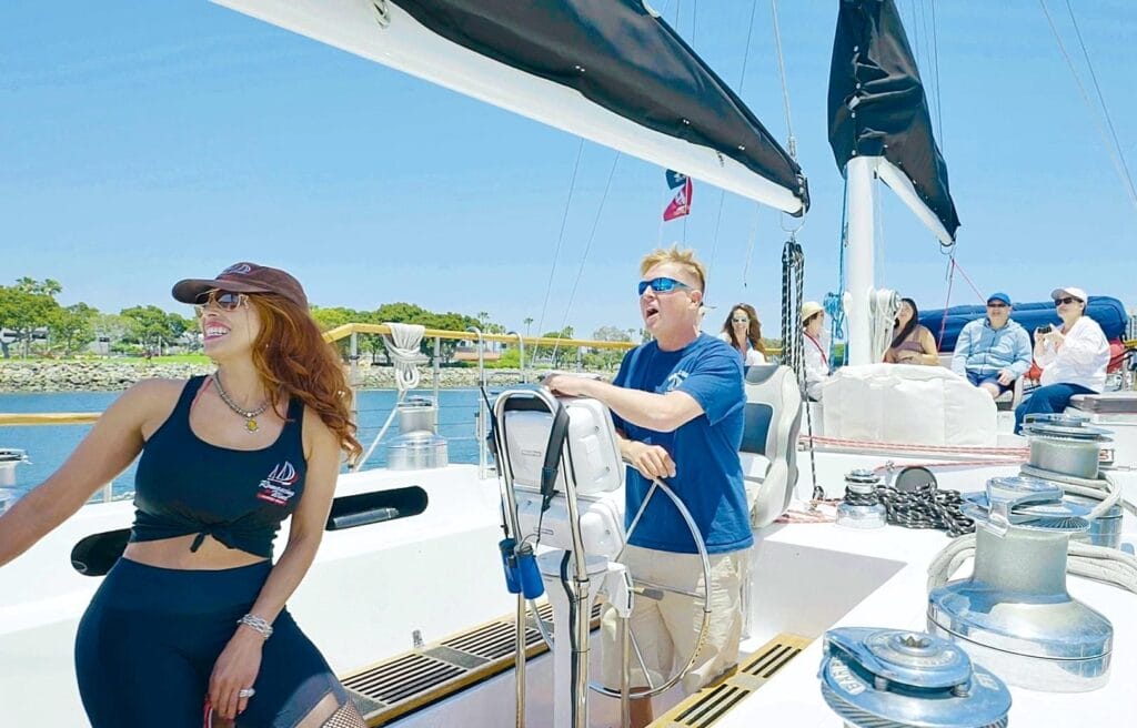 People enjoying a sunny day on sailboat.