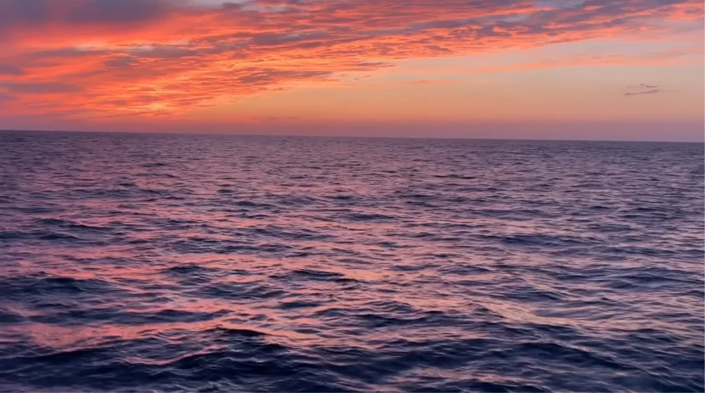Ocean sunset with vibrant orange and pink.