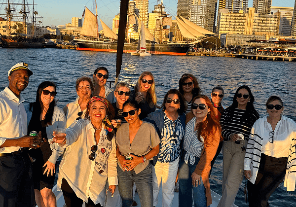 Smiling group on sunset harbor boat