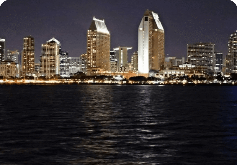 City skyline at night across the water.