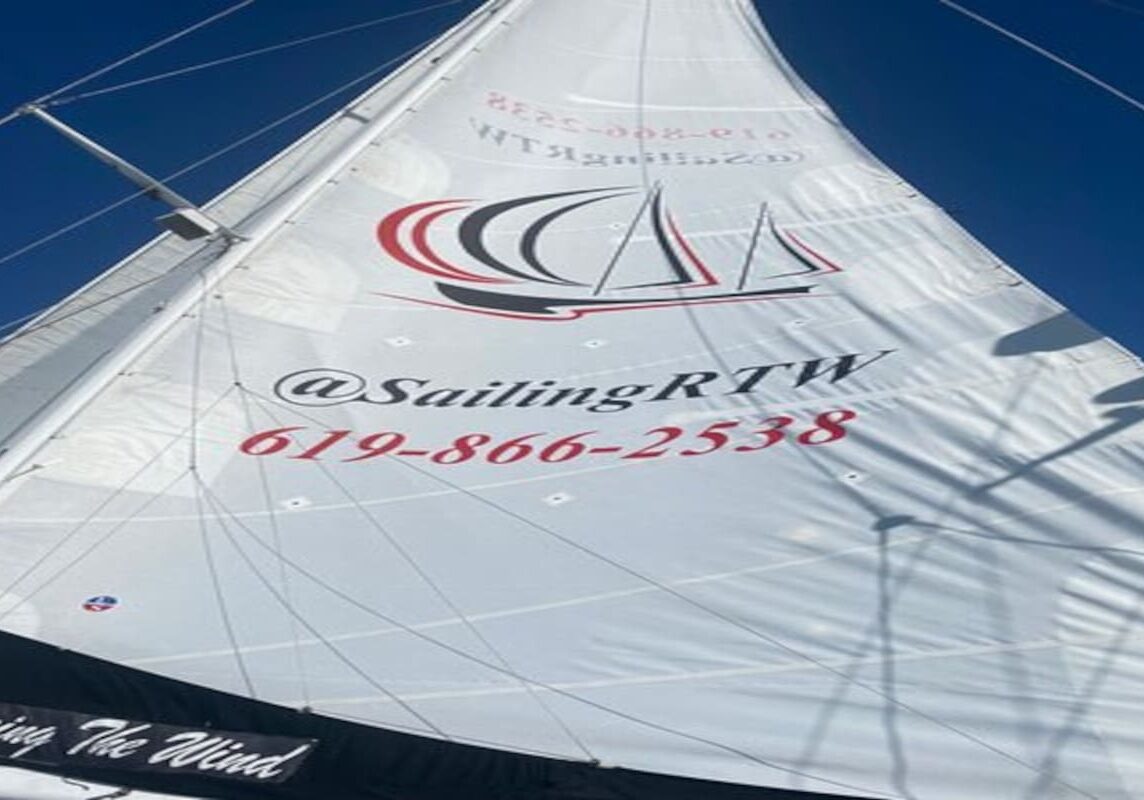 Close-up of sail displaying logo and contact
