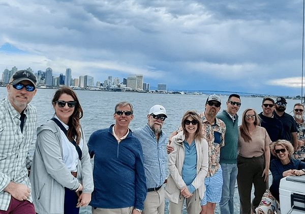 Smiling group on boat near city skyline