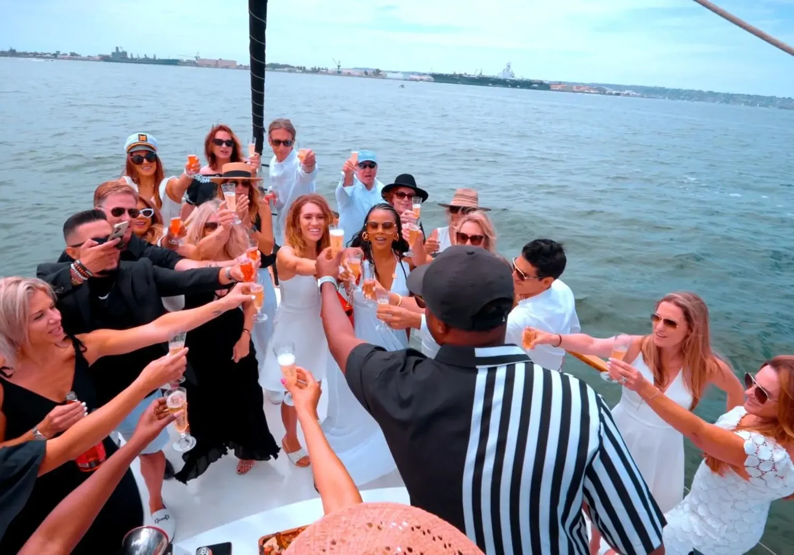 A group of friends enjoying a boat party on a sunny day.