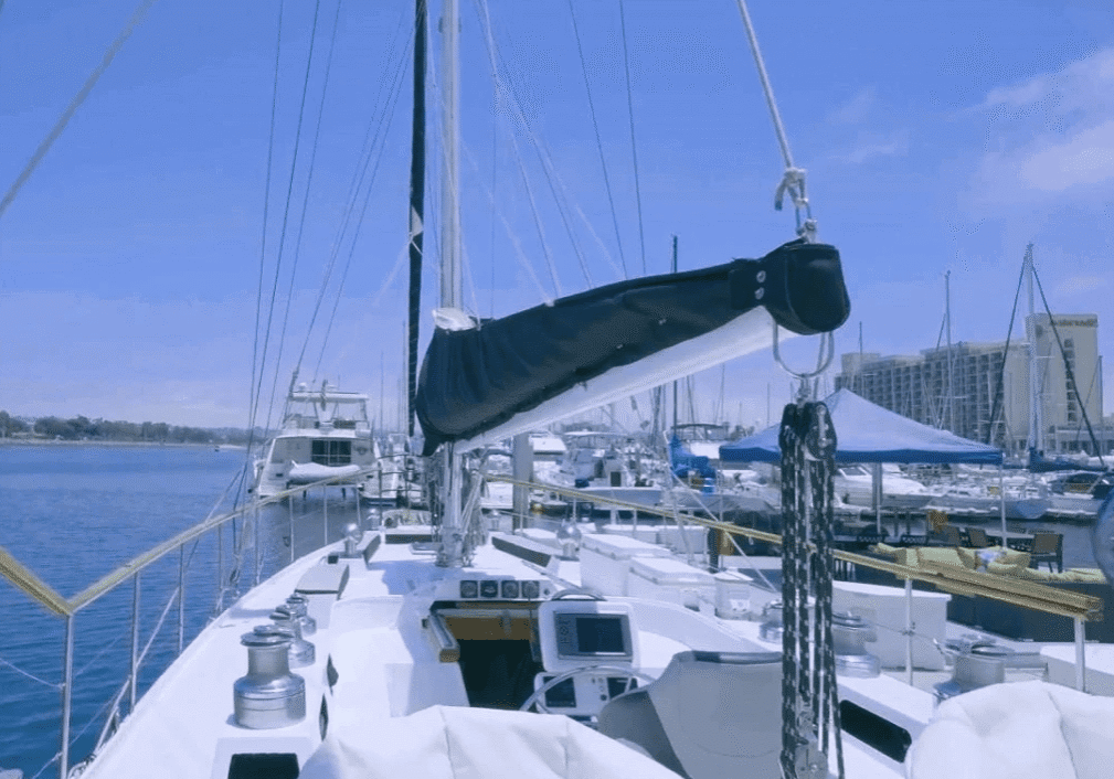 A sailboat docked at a marina on a clear day.