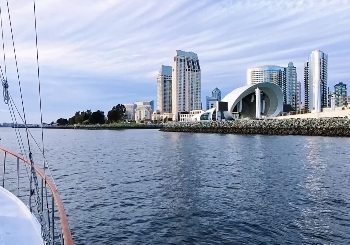 Bow of boat facing modern waterfront pavilion